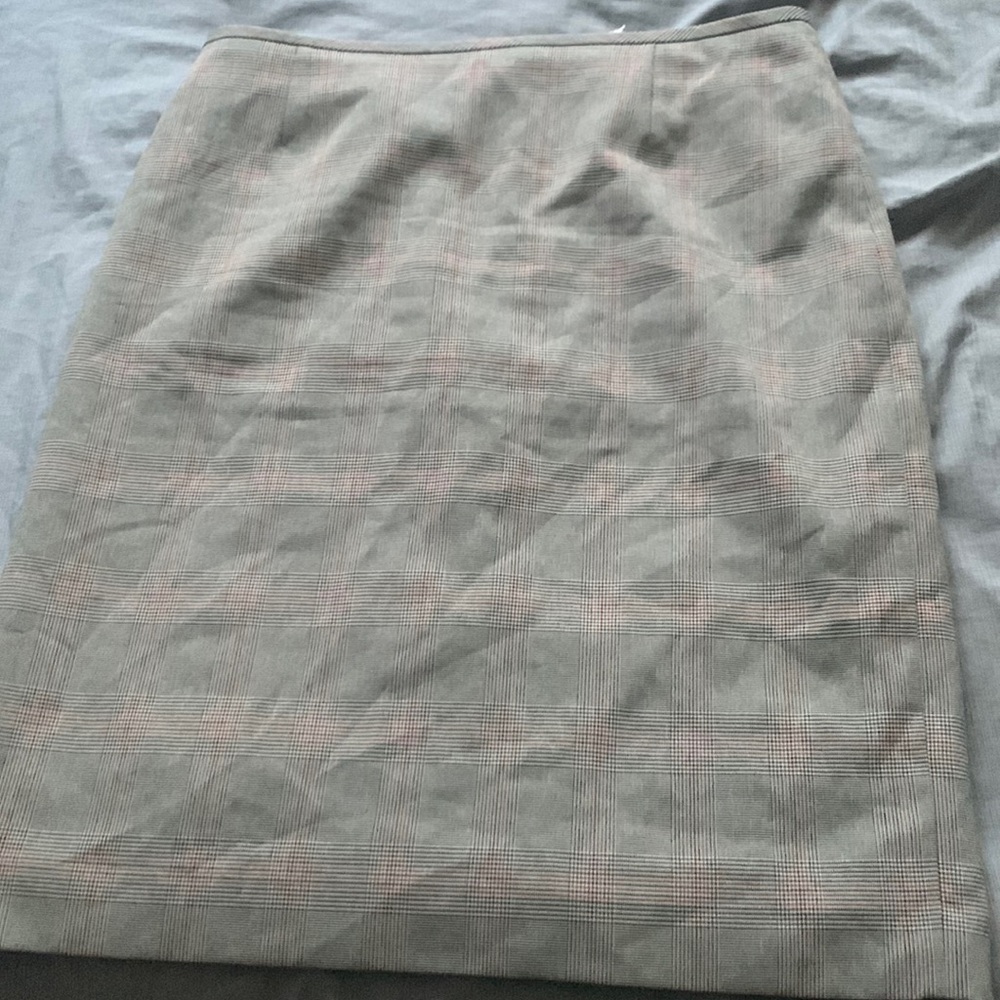 This is a size 8 skirt that is gray with red and black plaid color